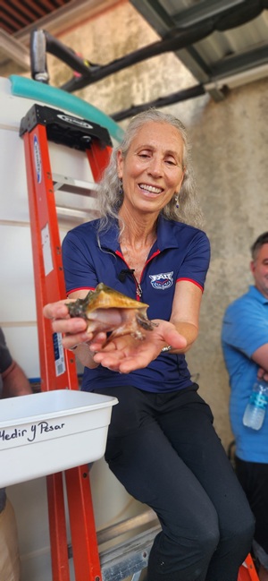 Megan Davis holding a queen conch