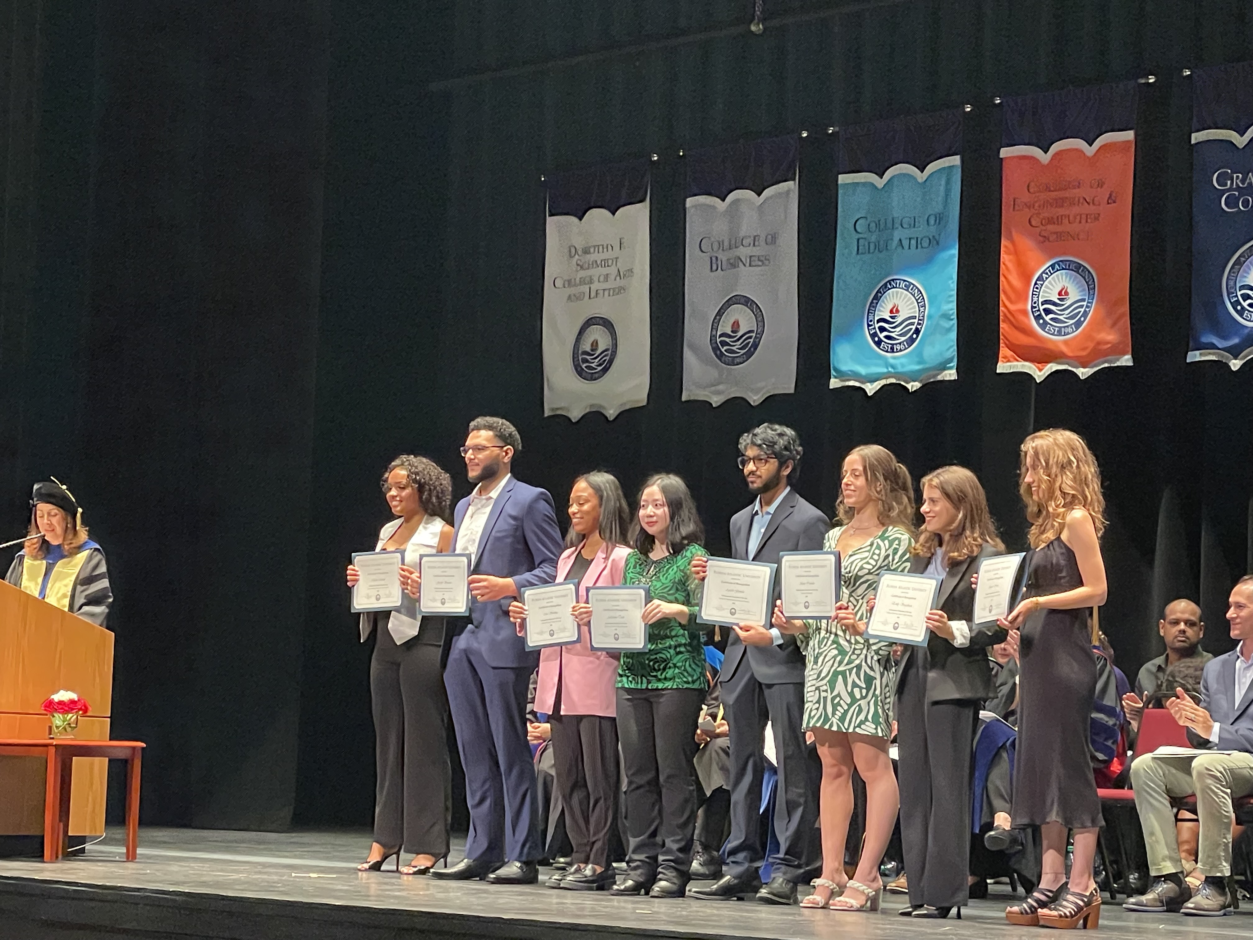 group of students in front of large window