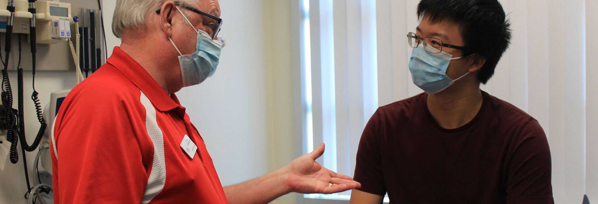 Health Office worker talking to student