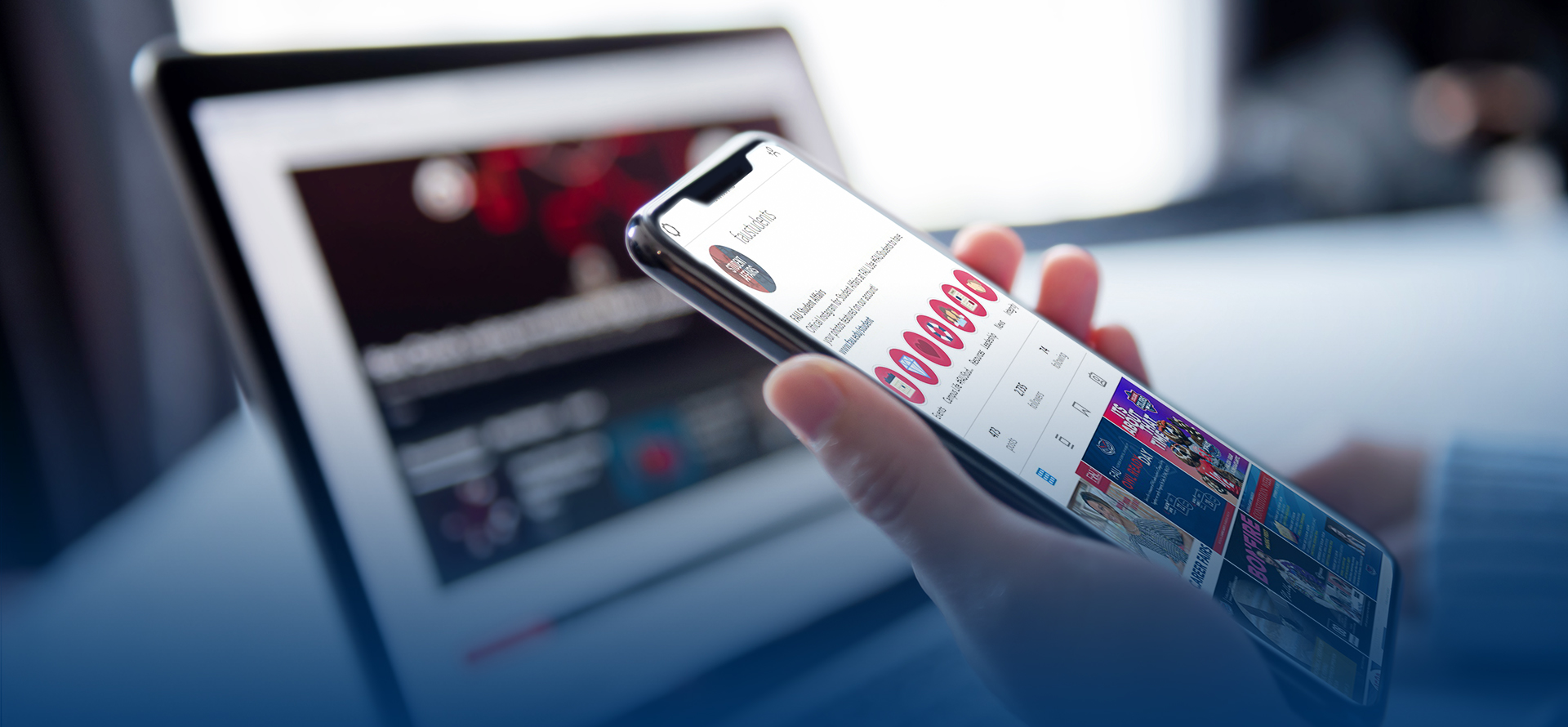 A hand holding a phone showing a 太阳城娱乐 social media account