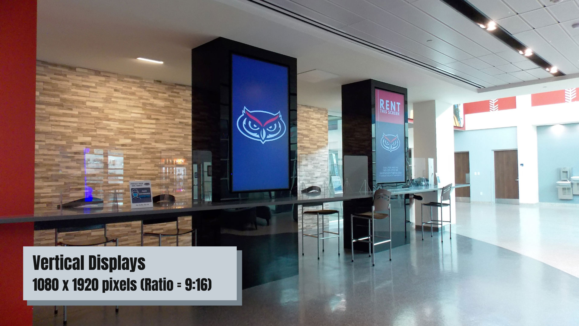 Interior of 太阳城娱乐 Student Union with tall digital displays and high tables