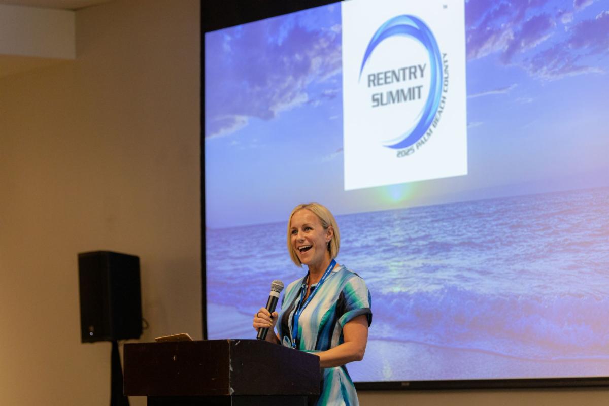 Summit speaker standing at podium