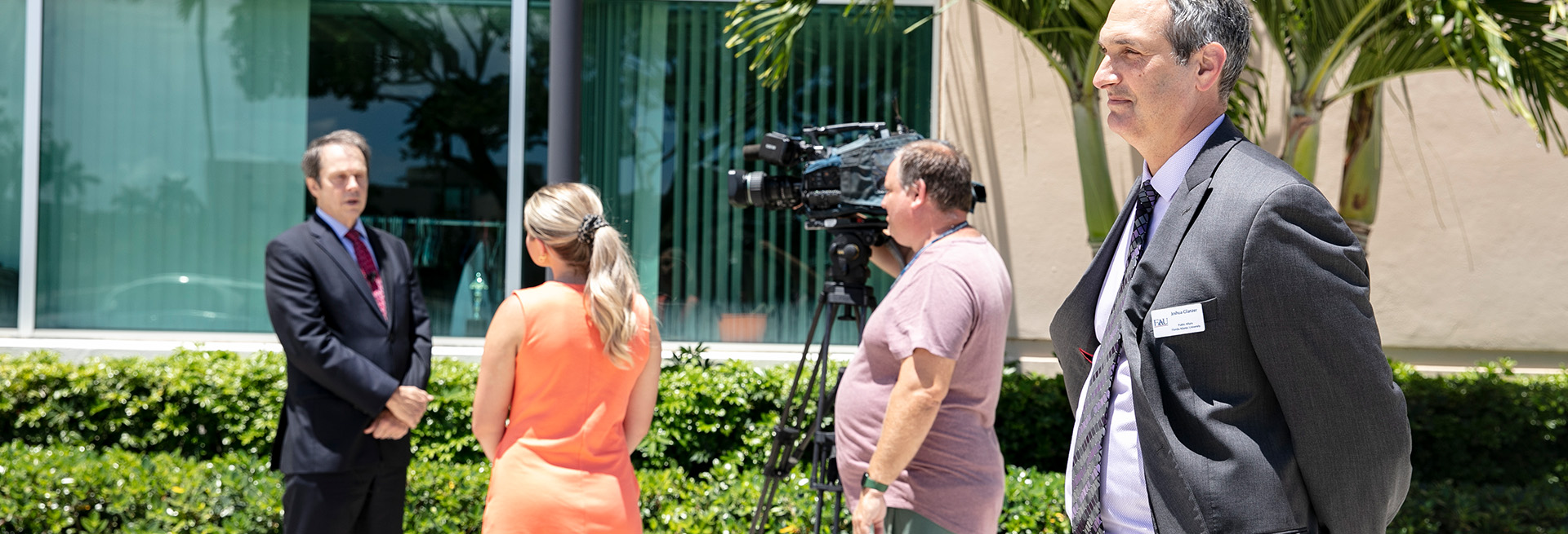 Media relations overseeing a news interview with the university president